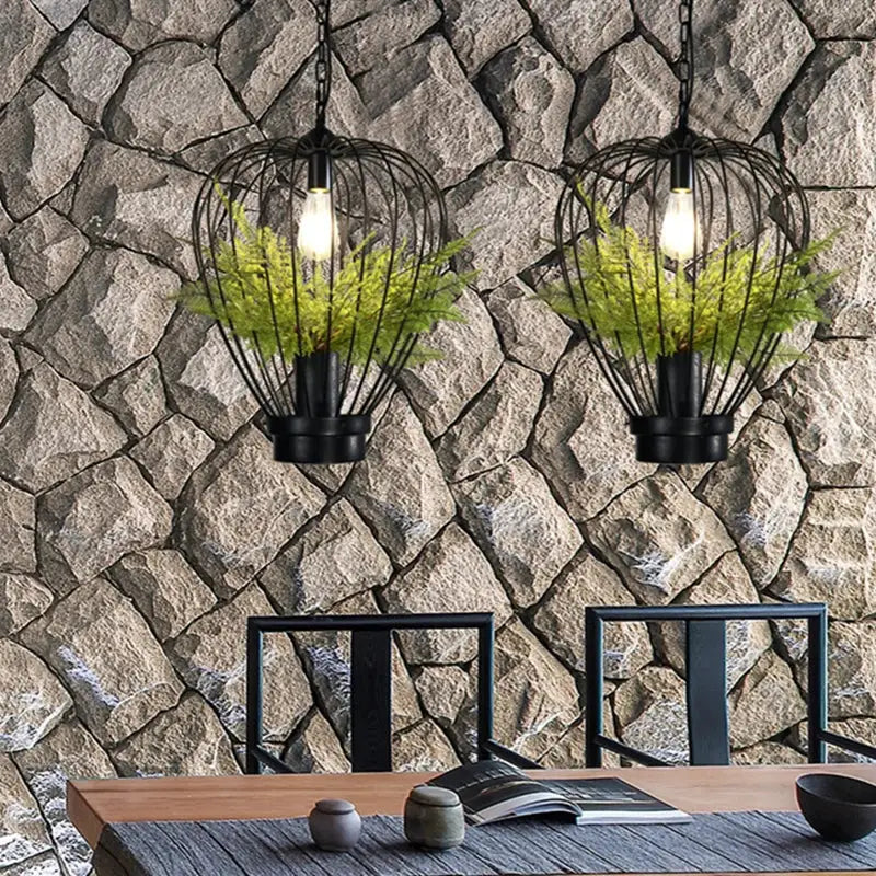 Industrial black green planting birdcage chandelier featuring black wrought iron cage pendant lights with green ferns inside