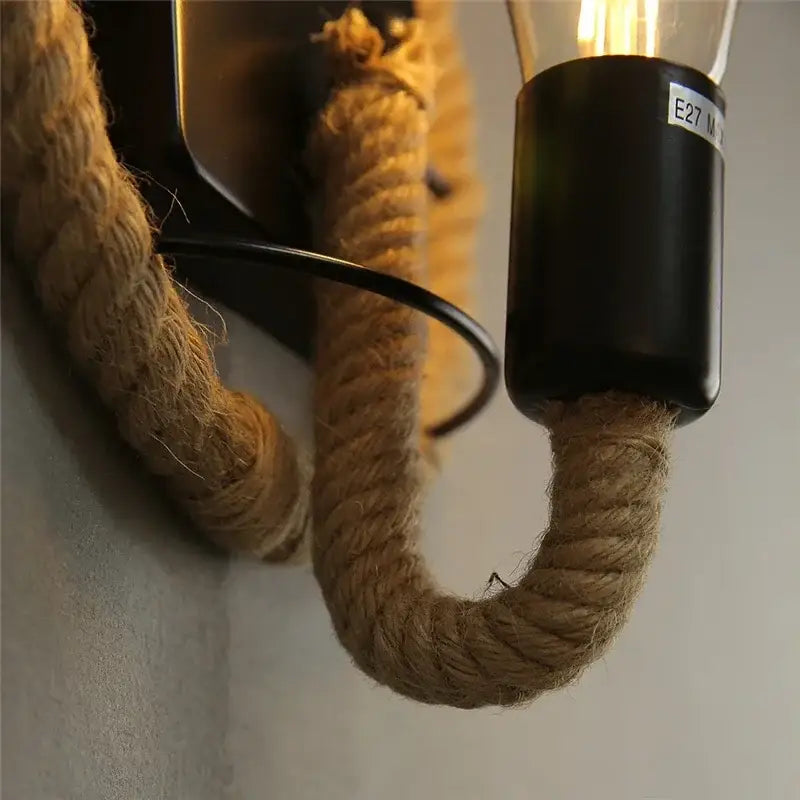 Industrial black hemp rope wall lamp with rope wrap, black base, and exposed filament bulb for living room decorbites hemp rope wall