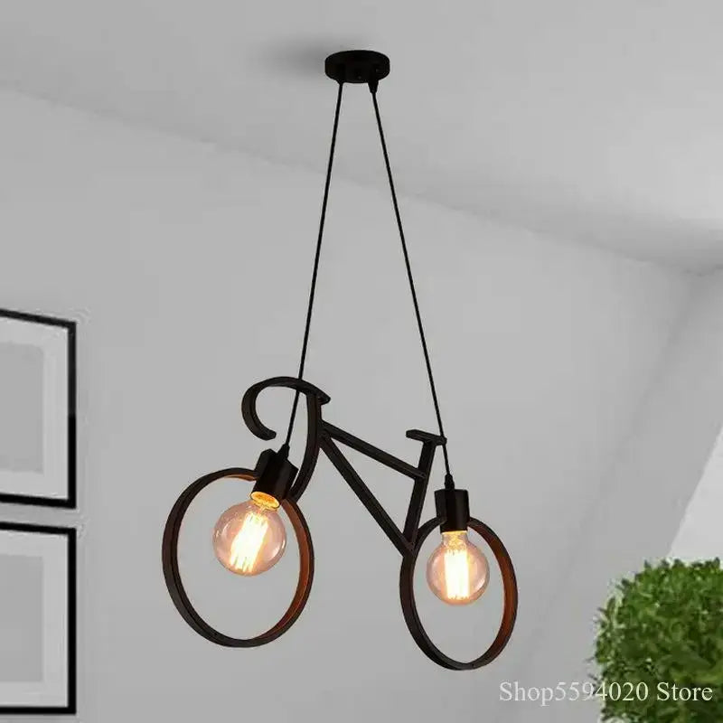 Industrial black iron bike chandelier features a black metal bicycle design with two exposed filament bulbs for dining room decorbites iron bike pendant