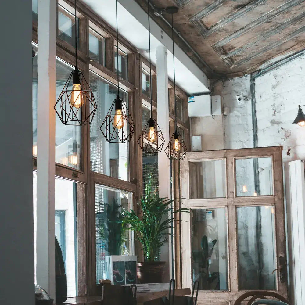 Industrial black iron cage chandelier kitchen pendant light with black geometric wireframe ceiling light and warm bulbs