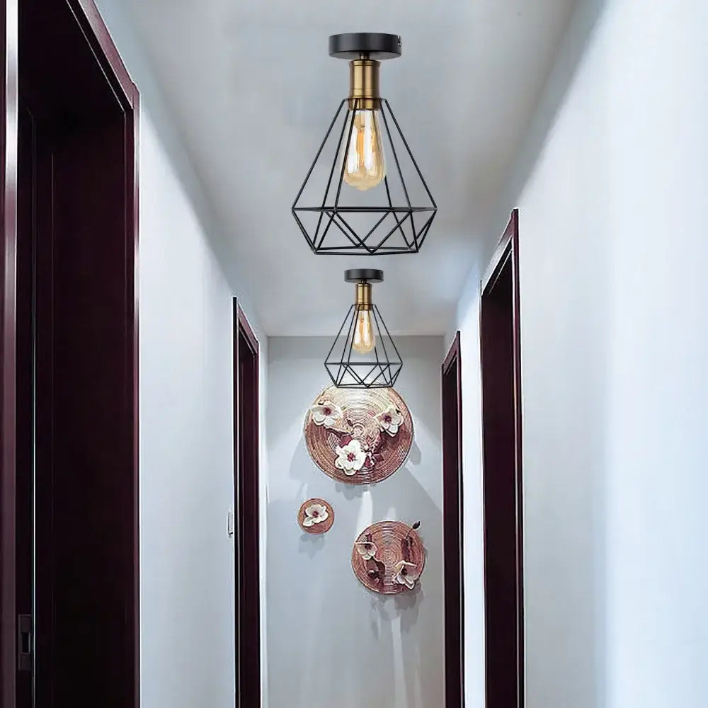 Industrial black iron cage led ceiling light with brass accents and exposed edison bulb for dining room decorbites iron cage