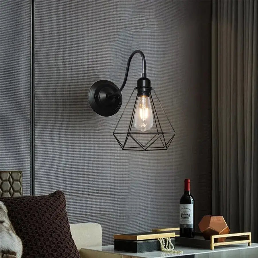 Industrial black iron cage wall sconce with geometric wire cage and exposed edison bulb for bedroom decorbites iron cage