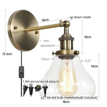 Industrial black iron led wall sconce with antique brass finish clear glass shade and exposed edison-style bulb decorbites black iron