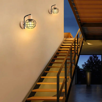 Industrial black iron wood wall lamp with cage-style design and warm glow for bedroom decorbites iron wood wall sconce
