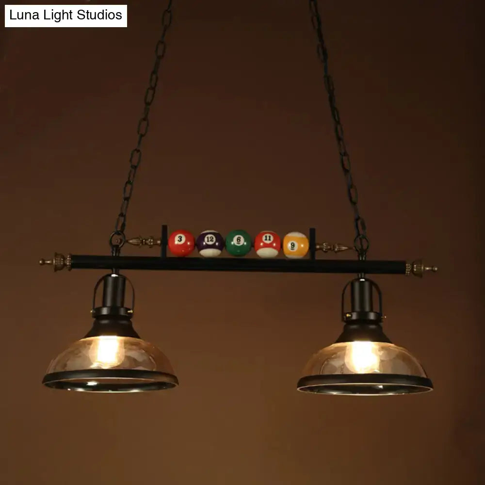 Industrial-style black island pendant light kit with clear glass dome shades and colorful billiard balls for pool tables