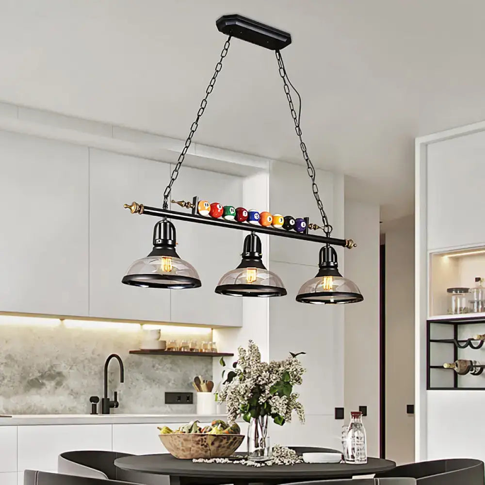 DecorBites™ rustic black island pendant light kit with clear glass shades and a bar holding colorful billiard balls