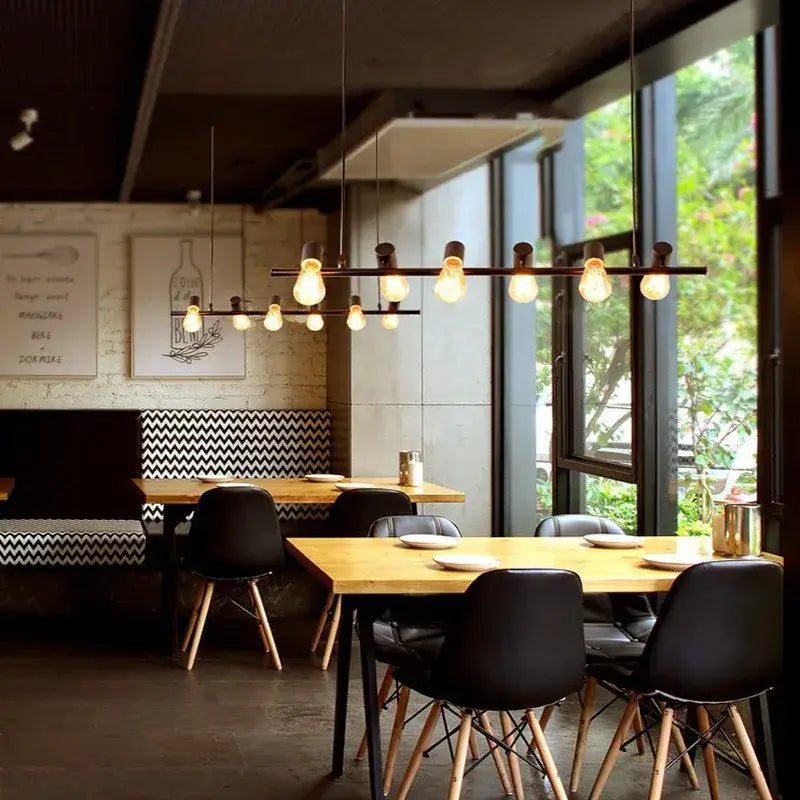 Industrial black kitchen island chandelier with multiple exposed edison bulbs on a dark metal bar for decorbites industrial kitchen island lighting