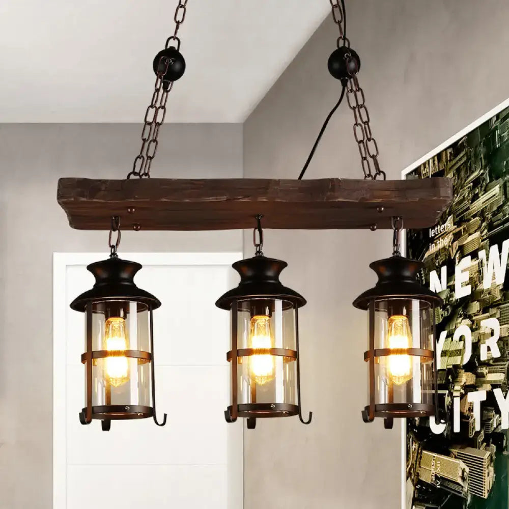DecorBites™ industrial pendant light with three dark wrought iron lanterns, clear glass, and rustic wood beam hanging lamp