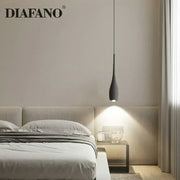 Industrial black matte cement pendant light with sleek teardrop design hanging above bedroom bed decorbites cement pendant