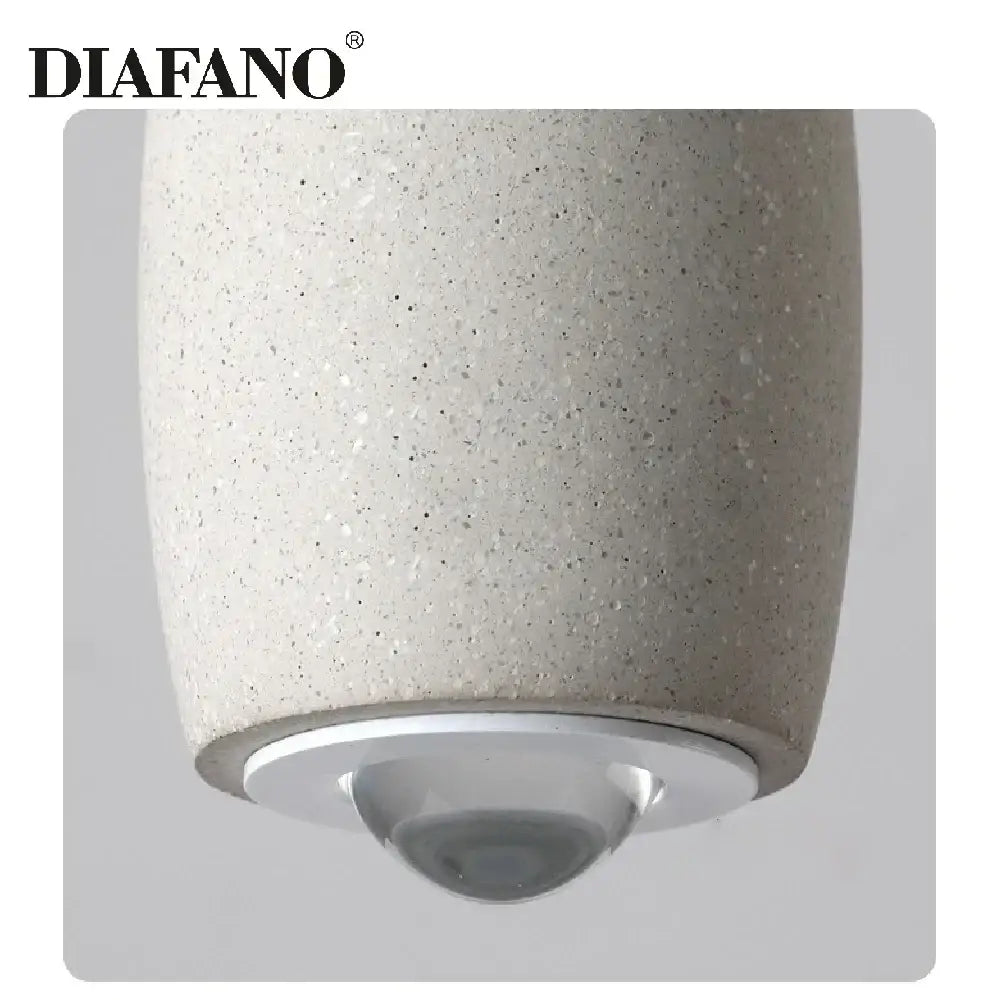 Diafano pendant light with speckled beige cement finish and metallic silver base ideal for industrial bedroom decorbites cement pendant