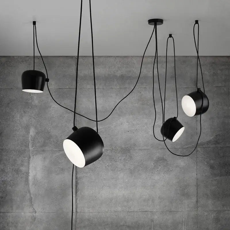 Industrial black matte spider pendant lamp with sleek cylindrical shades and exposed cords for dining room decorbites industrial spider