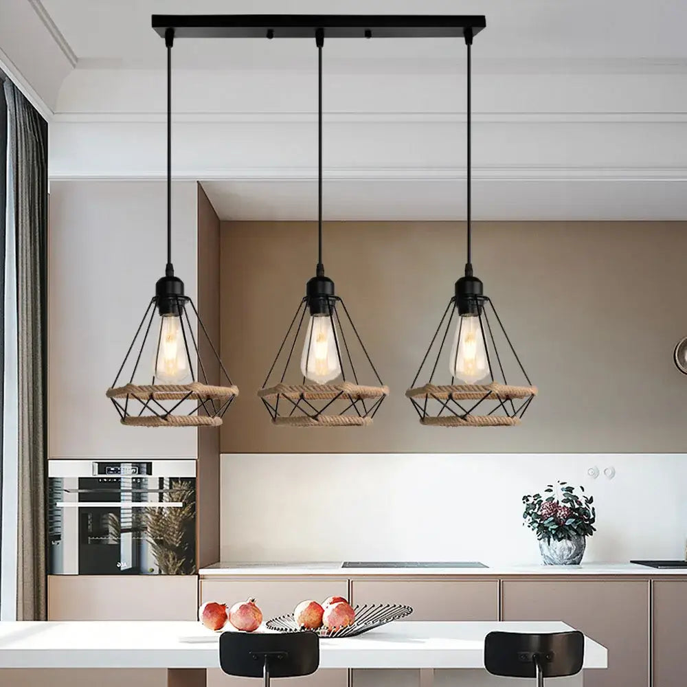 Three black industrial hanging lamps with metal and woven rope accents by decorbites above kitchen island