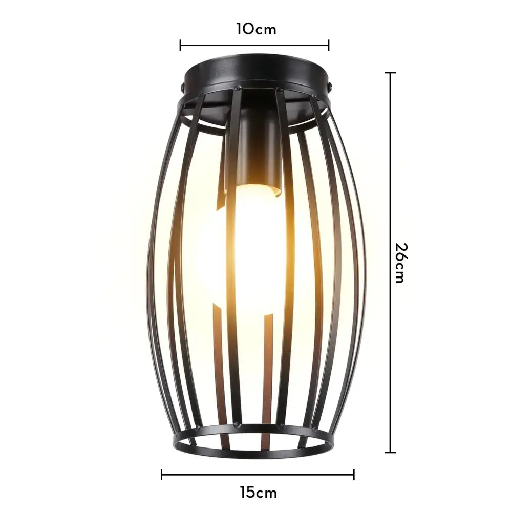 Black metal cage ceiling light with vertical bars and warm glowing bulb decorbites industrial led kitchen fixture