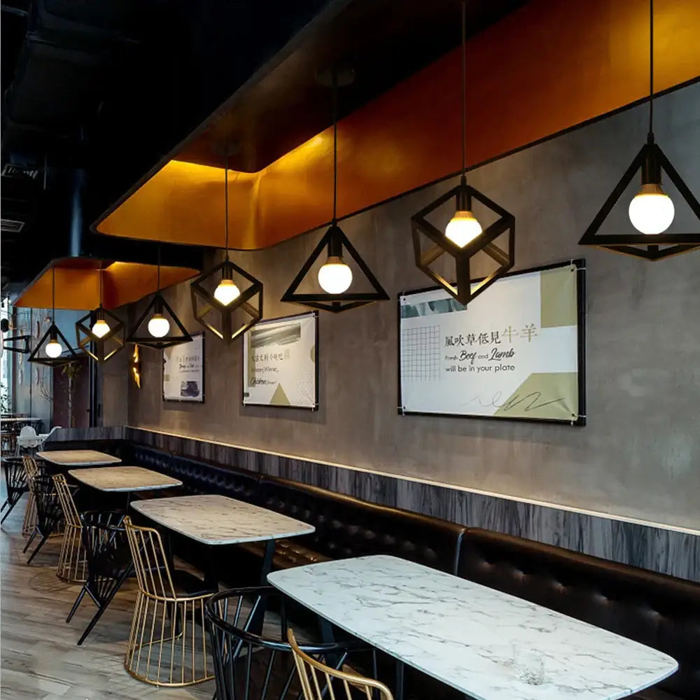 Industrial black metal cage pendant light with warm-toned bulbs ideal for kitchen decorbites industrial led pendant use