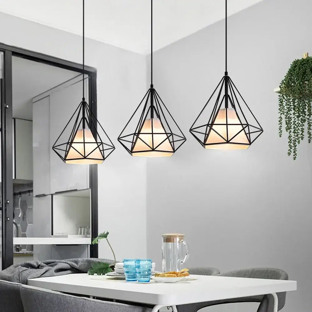 Three black metal cage pendant lights with warm glow for kitchen decorbites industrial led pendant lighting