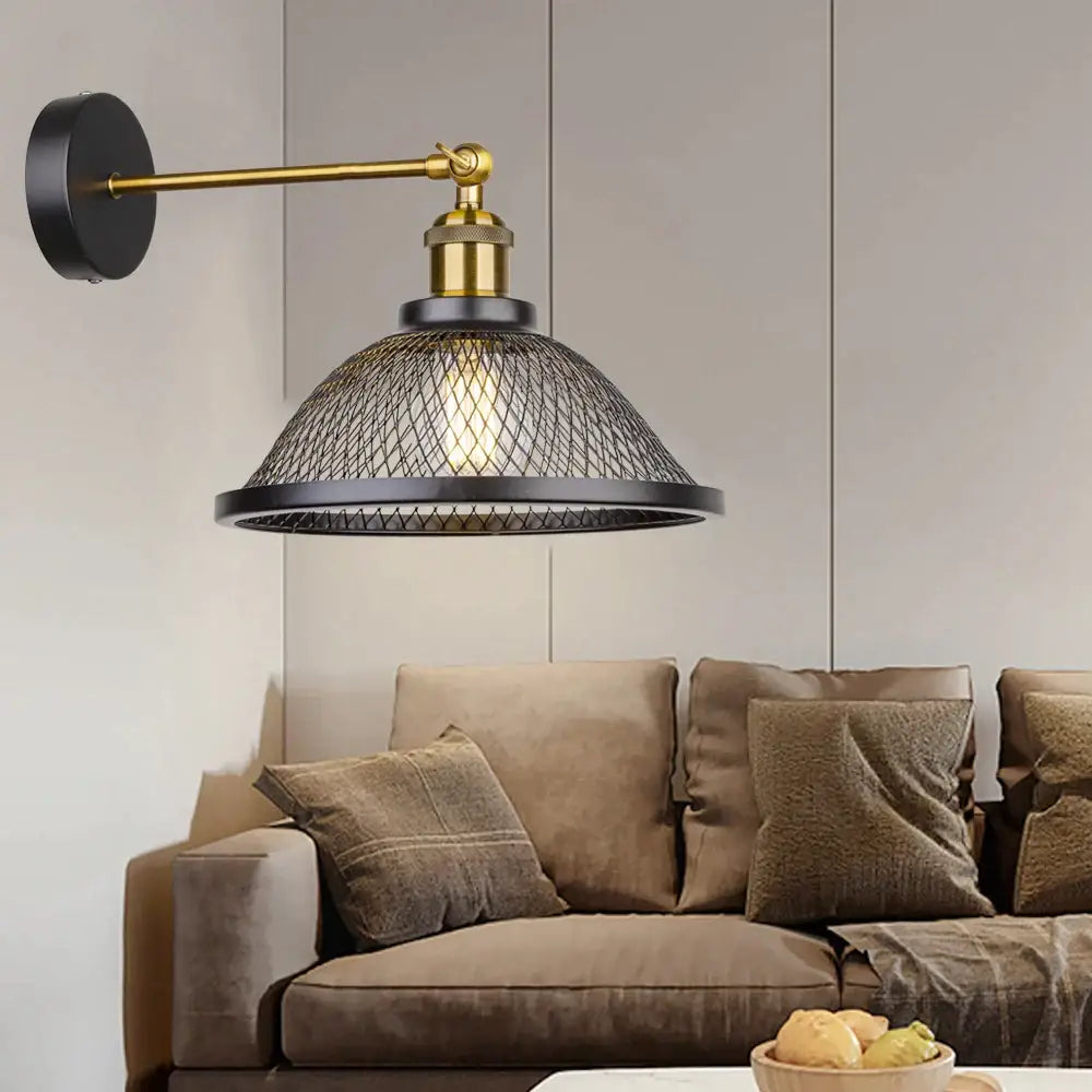 Industrial black metal cage wall lamp with brass finish and black mesh shade for bedroom decorbites black metal sconce
