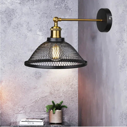 Industrial black metal cage wall lamp with brass accents and a black mesh shade for bedroom decorbites wall lamp