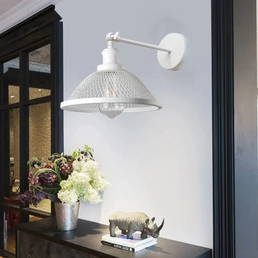 White industrial-style wall lamp with mesh shade and adjustable arm in decorbites black metal cage brass sconce design