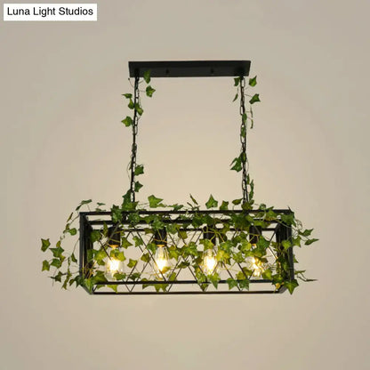 Black metal cuboid plant island light fixture with exposed bulbs and hanging green ivy vines for dining room use