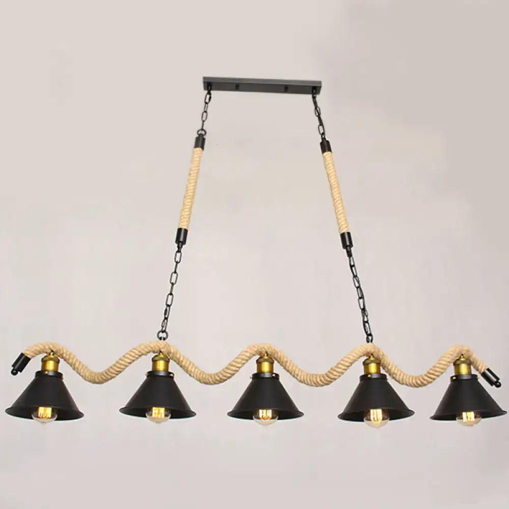 Industrial black metal island chandelier with five conical shades suspended by beige rope and brass accents