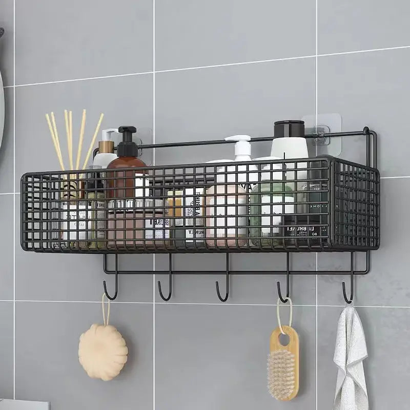 Black metal mesh two tier wall shelf organizer with five hooks holding toiletries and hanging loofah and brush