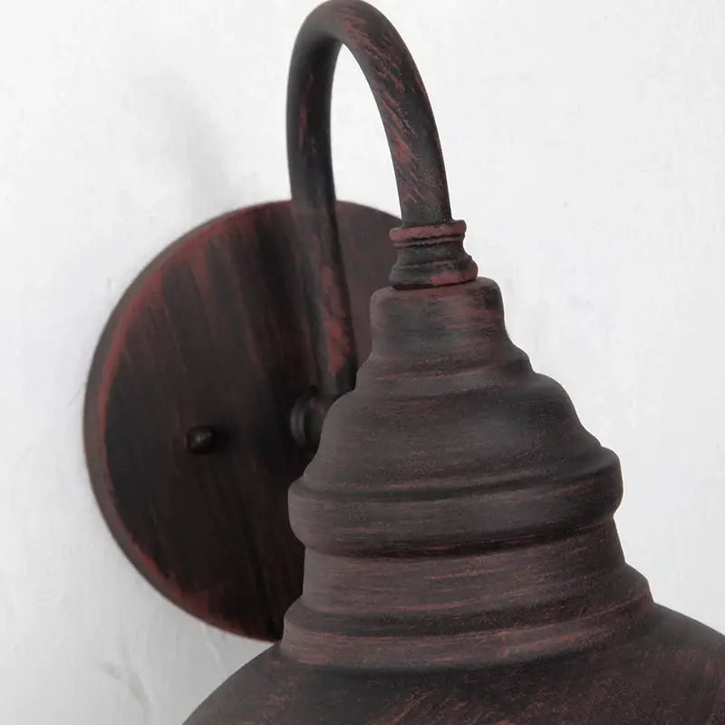 Rustic dark bronze farmhouse-style wall lamp with distressed finish and curved arm by decorbites industrial led outdoor
