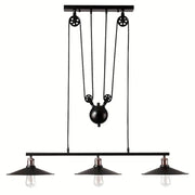 Industrial black metal pulley pendant light with three exposed bulbs and central pulley system for kitchen island use