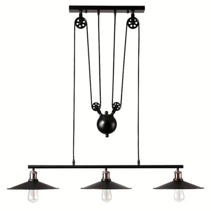 Industrial black metal pulley pendant light with three exposed bulbs and central pulley system for kitchen island use
