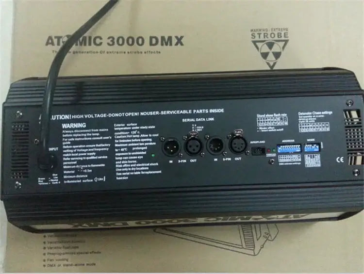 Industrial black metal strobe light showing back side with multiple input output ports and strobe flash atomic control interfaces