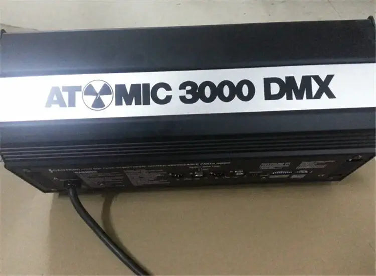Industrial black metal strobe light featuring a black atomic mic 3000 dmx lighting controller with flash atomic label