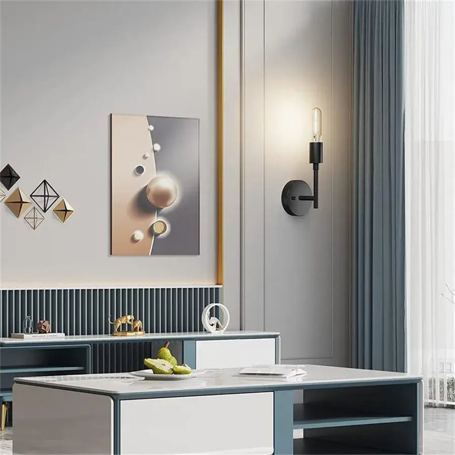 Modern black metal wall lamp with cylindrical base and exposed filament bulb for bathroom mirror decorbites black metal wall lamp