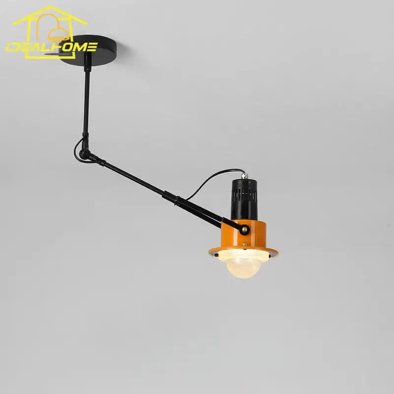 Orange and black articulated ceiling wall lamp with vintage industrial swing arm design by decorbites for bedroom light decor