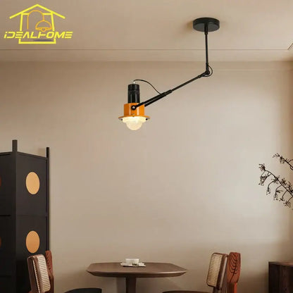 Industrial black and orange swing arm wall lamp with adjustable metal frame and frosted glass shade for bedroom decorbites industrial swing arm wall lamp
