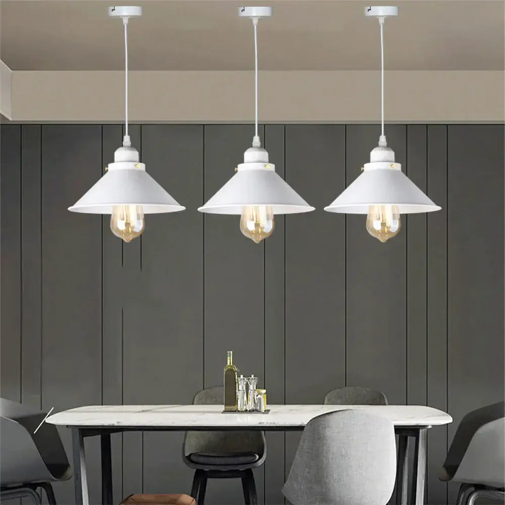 Three white pendant lights with conical shades featuring exposed Edison bulbs in decorbites industrial black pendant style