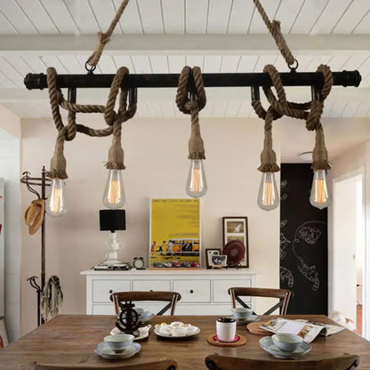 Industrial black pipe and rope chandelier with exposed filament bulbs for linear restaurant island lighting