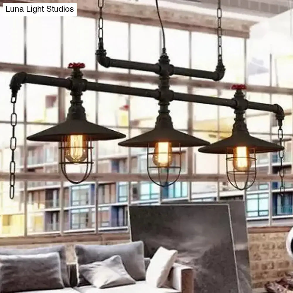 Industrial black pipe chandelier with red valve caps metal cage shades and three exposed filament bulbs for dining room use