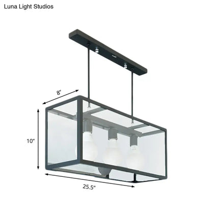 Black metal rectangular pendant light with clear glass panels and three exposed bulbs for industrial kitchen island use