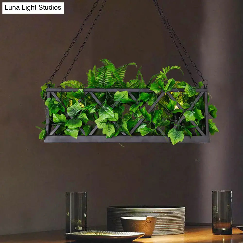 Black metal hanging planter with lattice design filled with artificial ferns paired with decorbites™ black rectangular island lighting fixture ceiling light