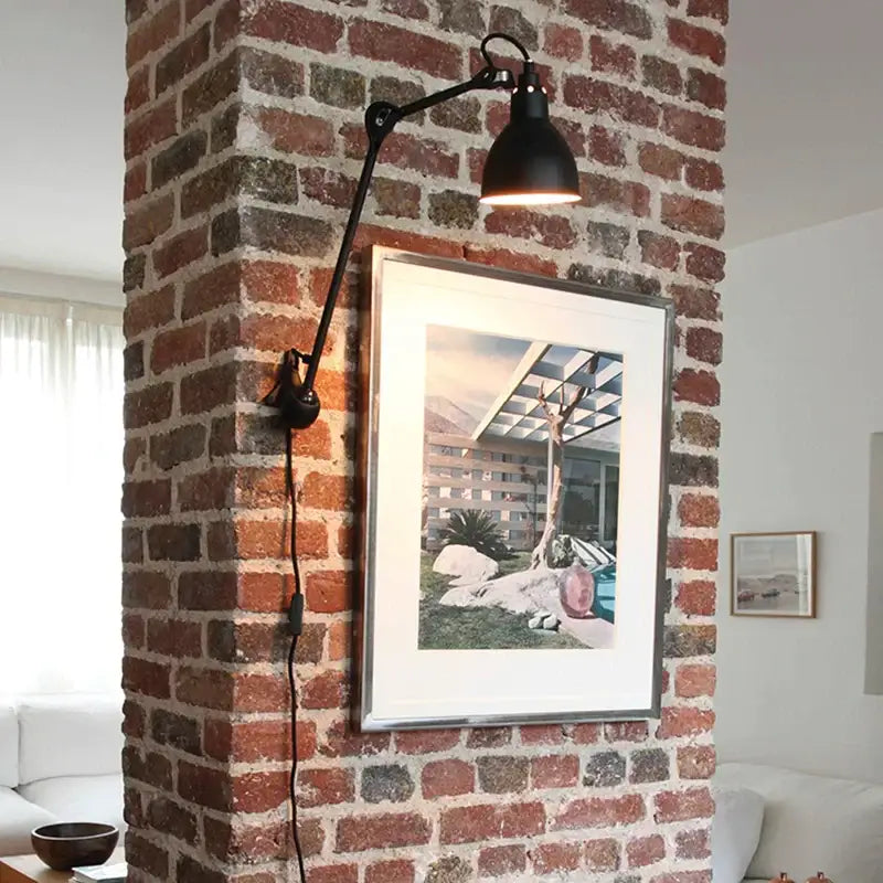 Black articulated wall lamp with matte finish and adjustable arm from decorbites industrial iron swing collection for bedroom decor
