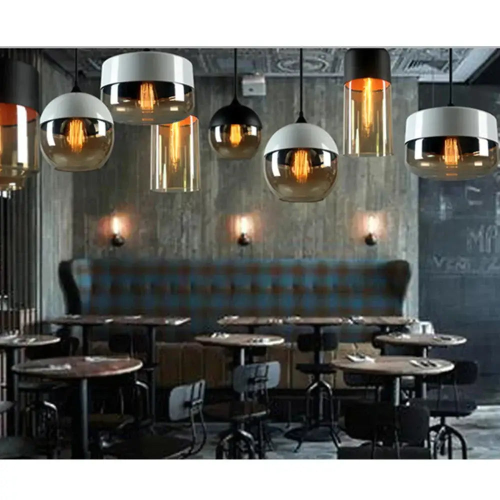Industrial black shade pendant light with smoked glass shades and exposed filament bulbs for kitchen decor