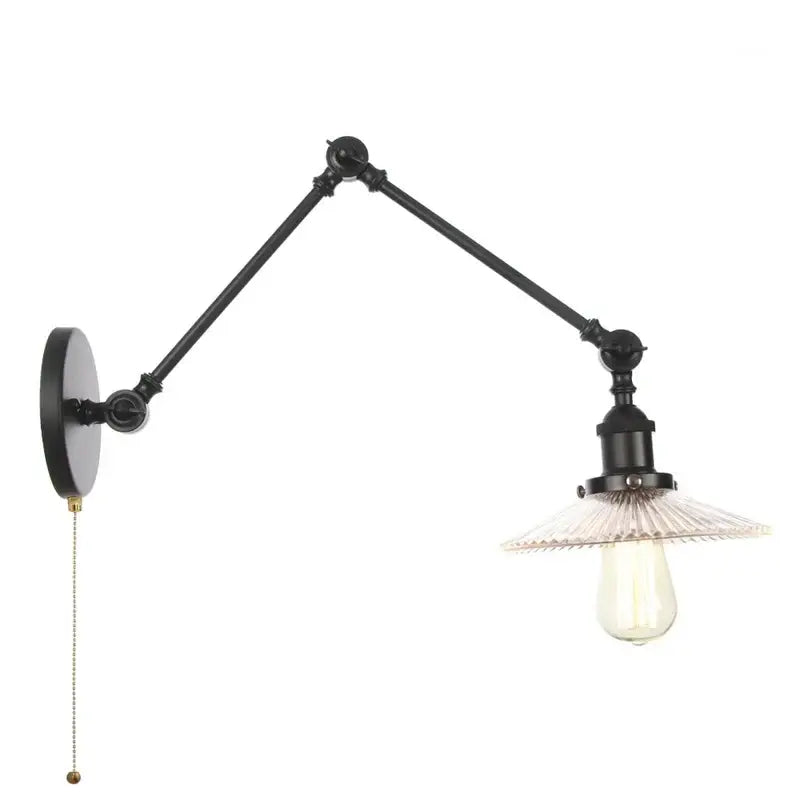 Industrial black swing arm wall light fixture with articulated arms and clear faceted glass shade over exposed bulb