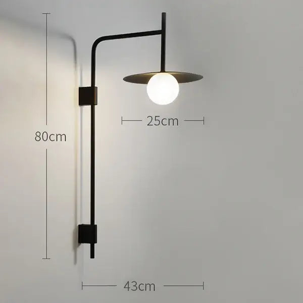 Black metal wall lamp with curved arm and frosted glass shade in decorbites industrial style for minimalist bedroom decor