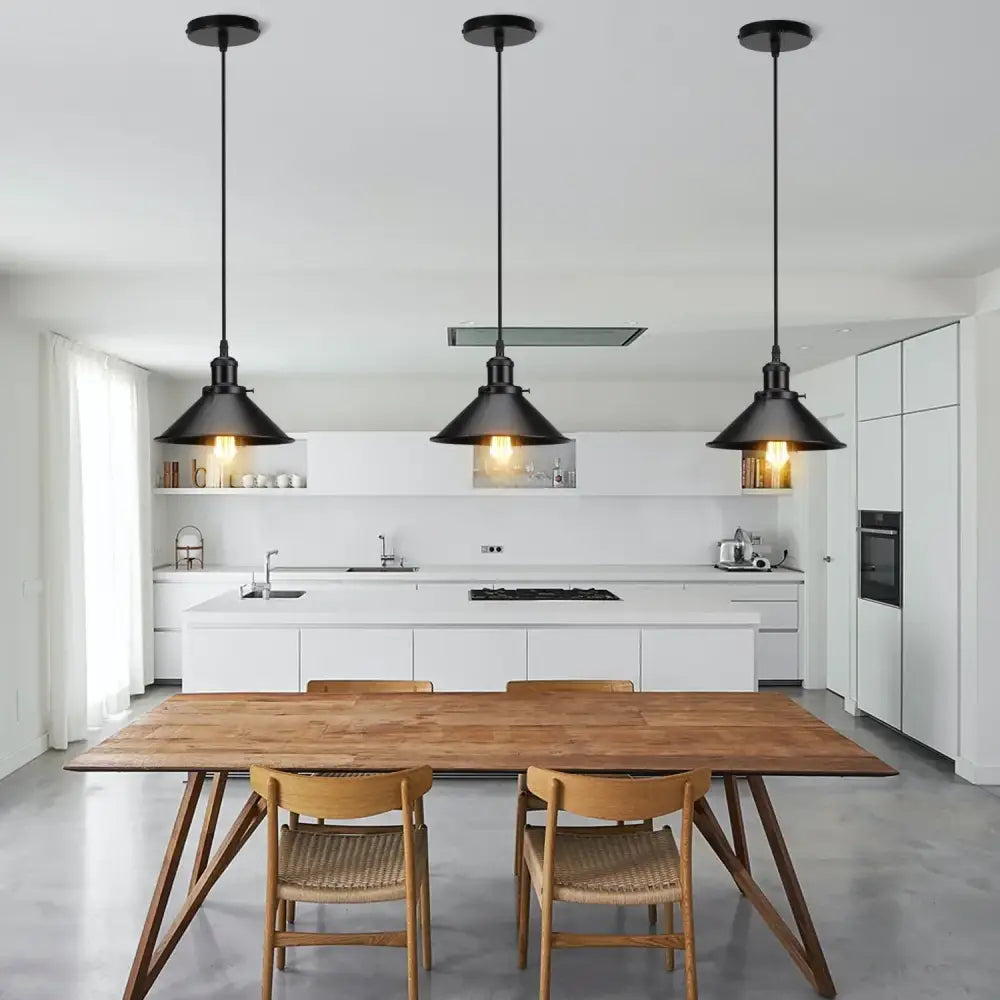 Three black iron pendant lights hang above a wooden dining table enhancing modern decorbites iron pendant light decor