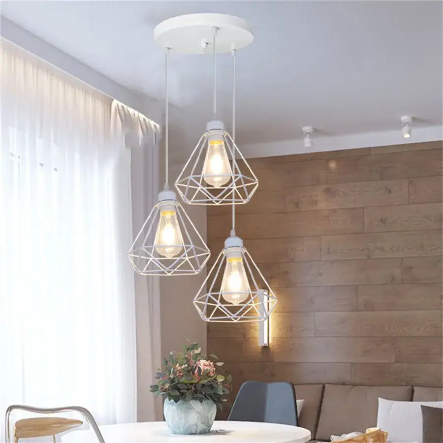White geometric wire pendant light featuring exposed bulb filaments in diamond cage wrought iron design