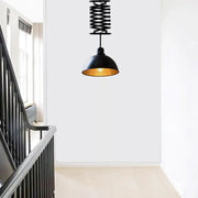 DecorBites industrial style black pendant light with gold interior and telescoping spring suspension in black white finish