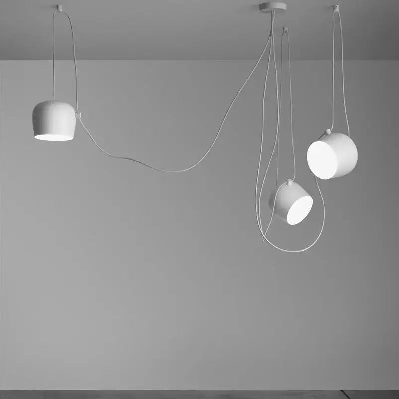 Modern white cylindrical pendant light with sleek minimalist design and flexible cords for decorbites industrial black white decor