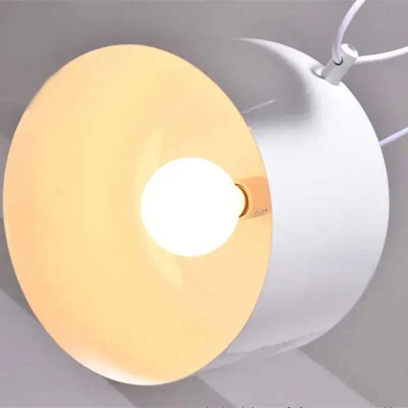 Modern white pendant light with warm diffused glow from circular shade in decorbites industrial black white style