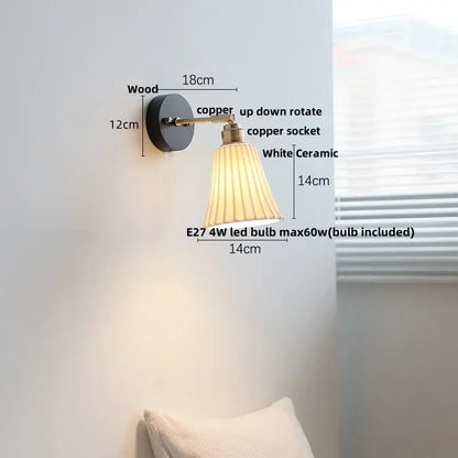 Industrial black wood led wall sconce with brass accent featuring a black wooden base, copper arm, and white pleated shade