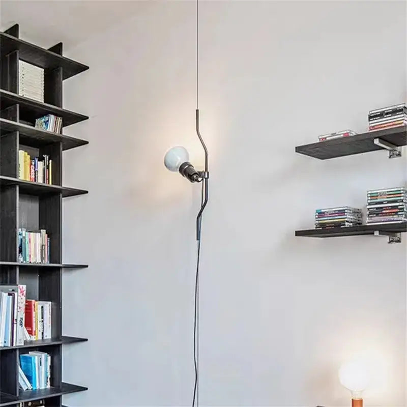 A sleek industrial black wrought iron adjustable pendant lamp with a curved arm and off-white bulb for bedroom decorbites decor
