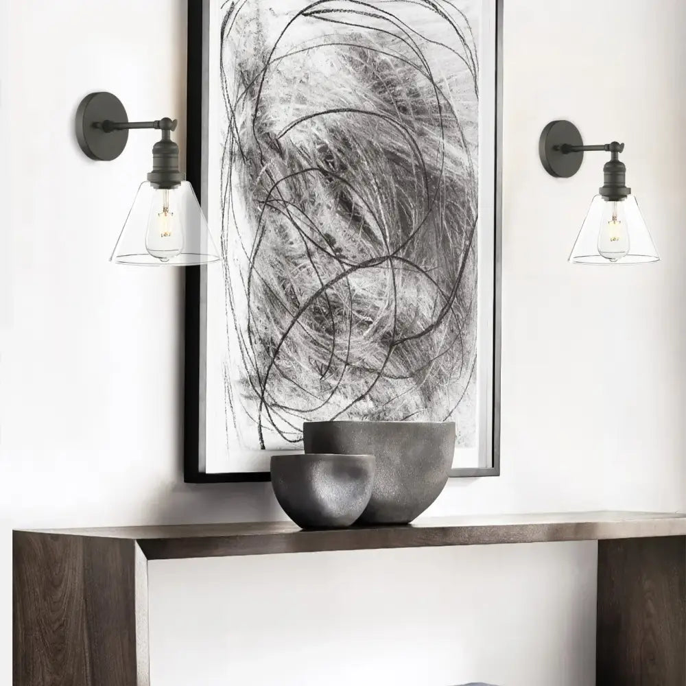 Industrial black wrought iron wall lamp with clear glass shade and exposed filament bulbs for bedroom use